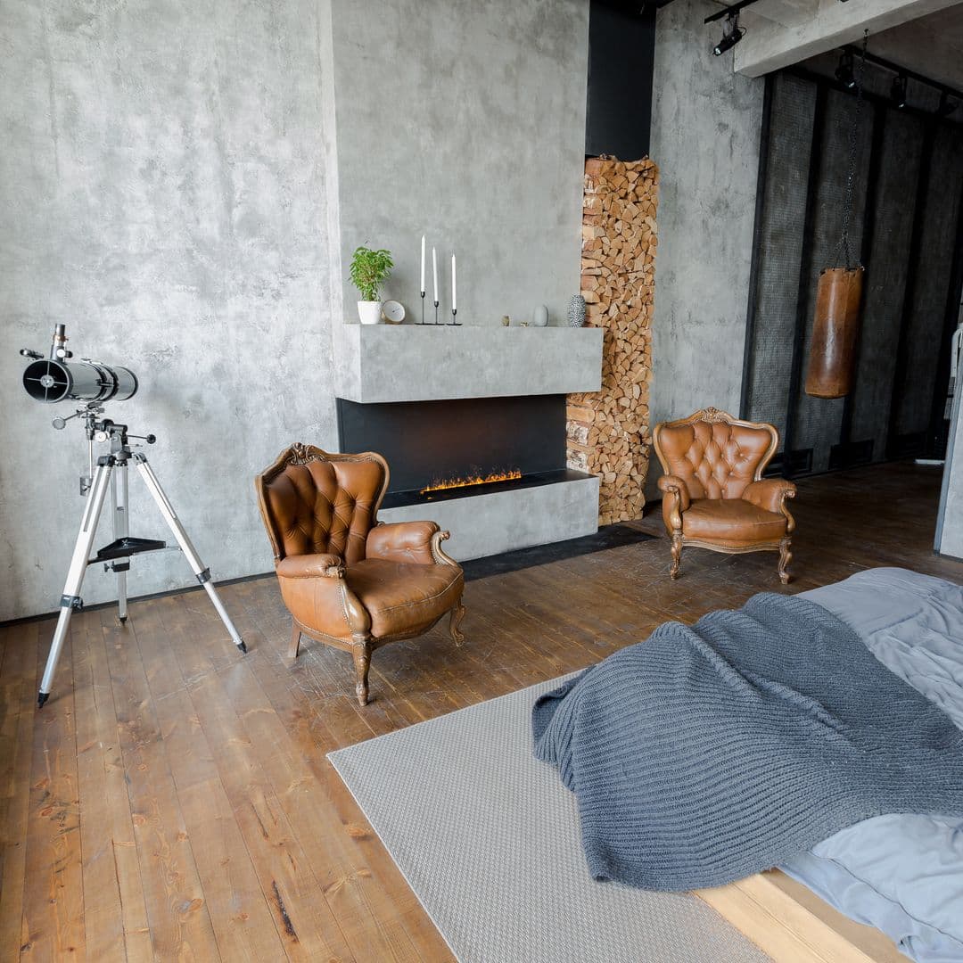 Schlafzimmer mit Kamin und Wand im Betonlook 